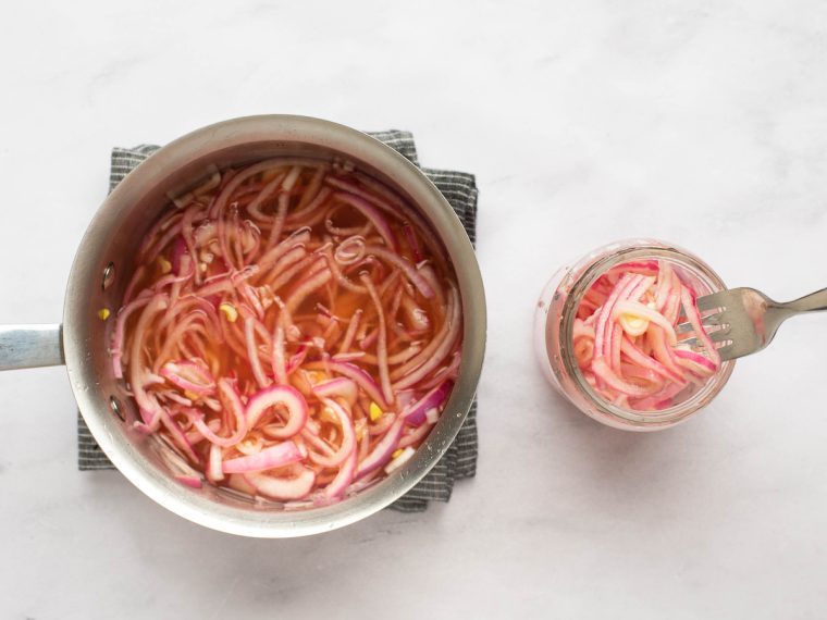 transferring onions to a jar