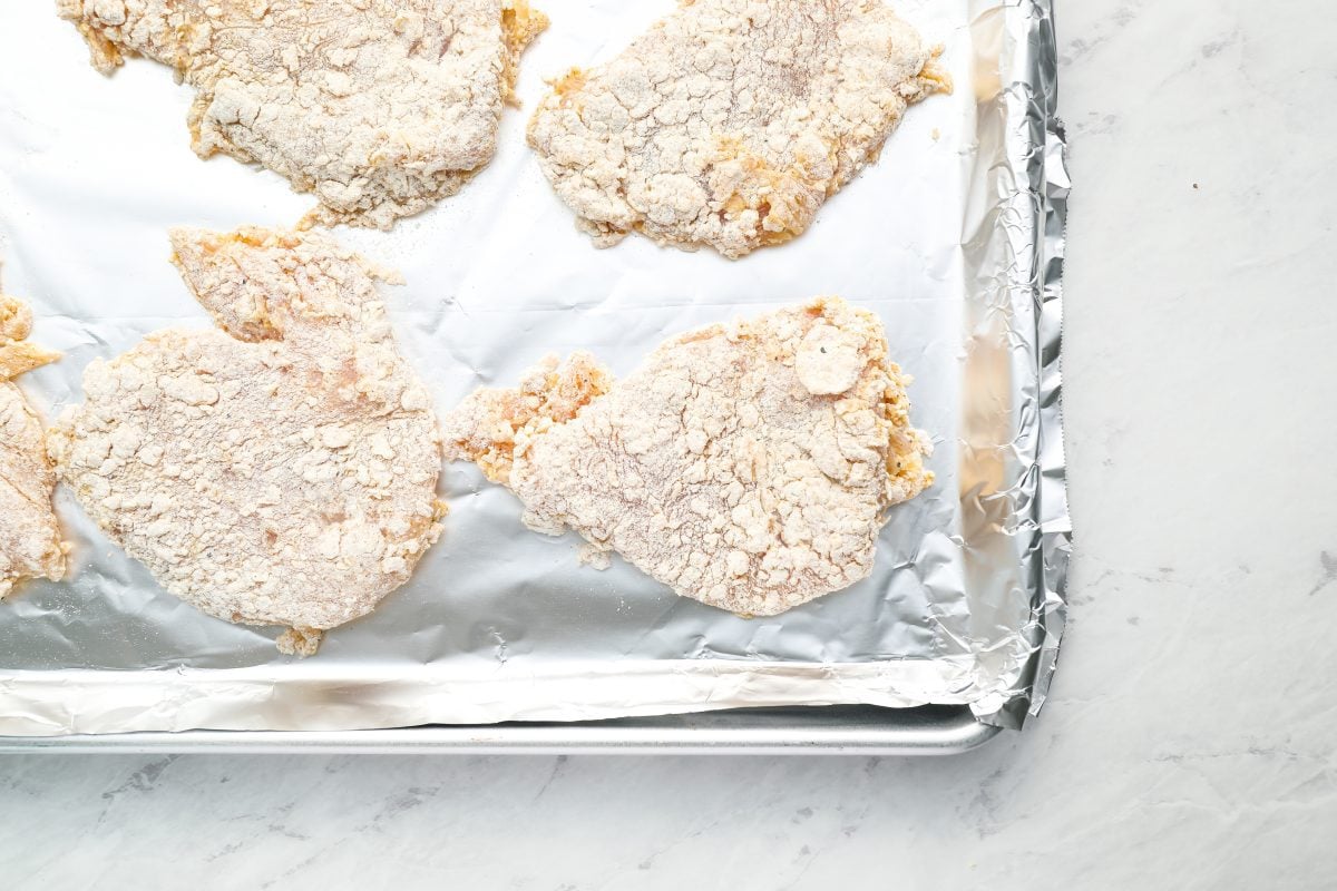 breaded chicken on baking sheet