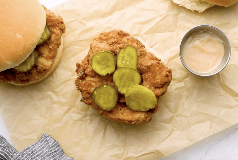 crispy pickles over fried chicken on bun