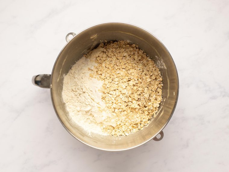 adding flour and oats to mixing bowl