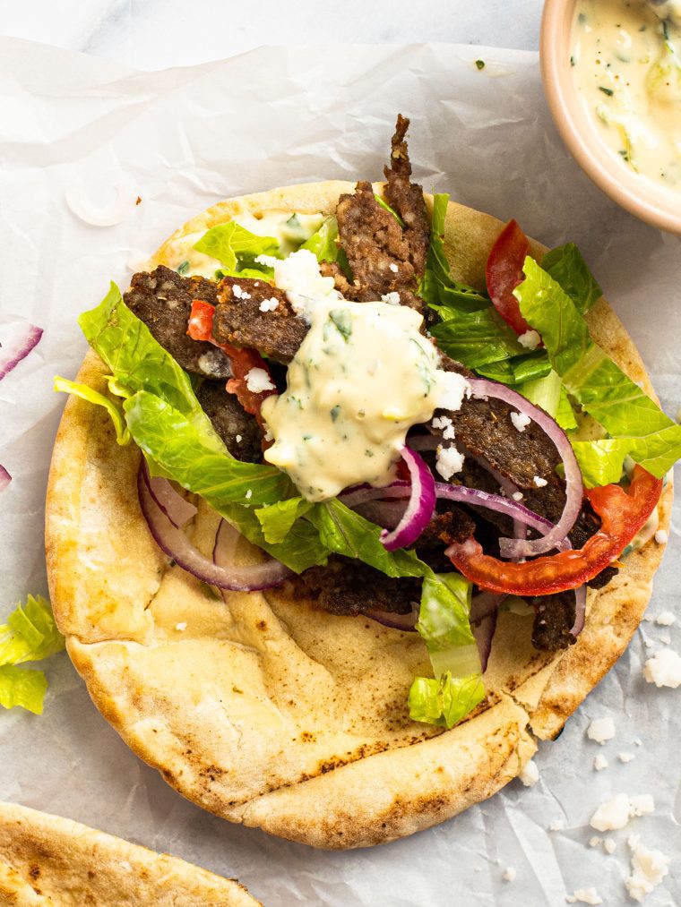 Gyro topped with a dollop of tzatziki sauce.