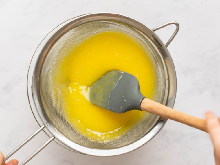 lemon curd in mesh strainer