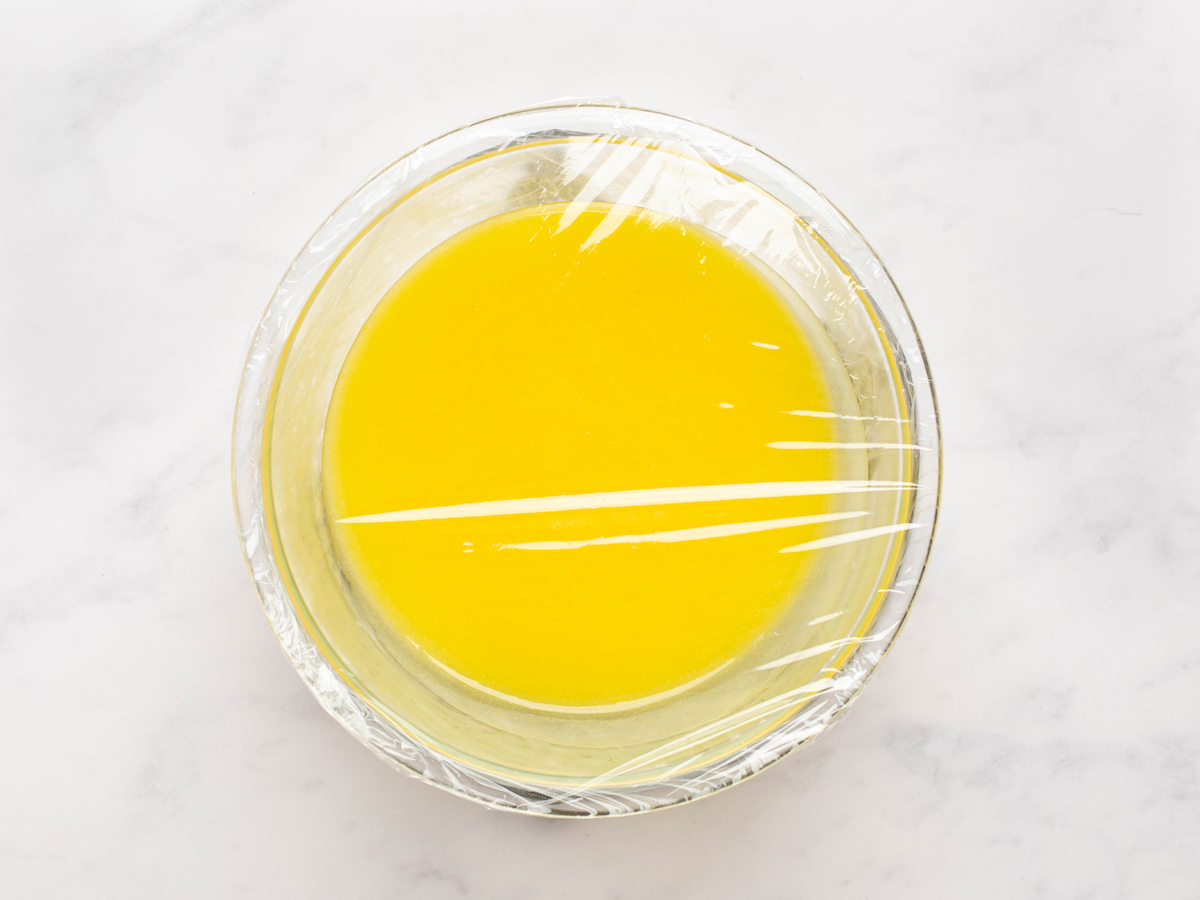 lemon curd in bowl, covered with plastic wrap