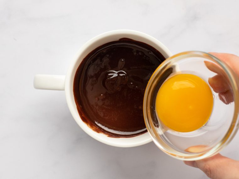 adding egg yolk to mug