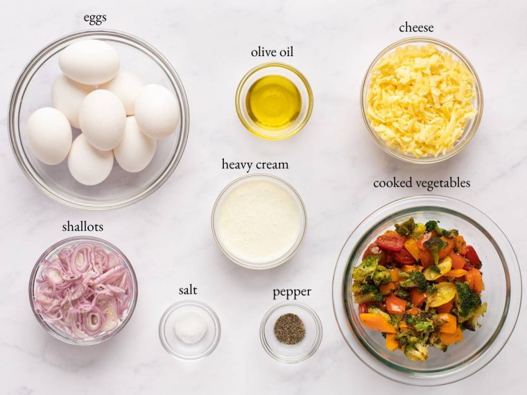 Frittata ingredients including cooked vegetables, heavy cream, and cheese.