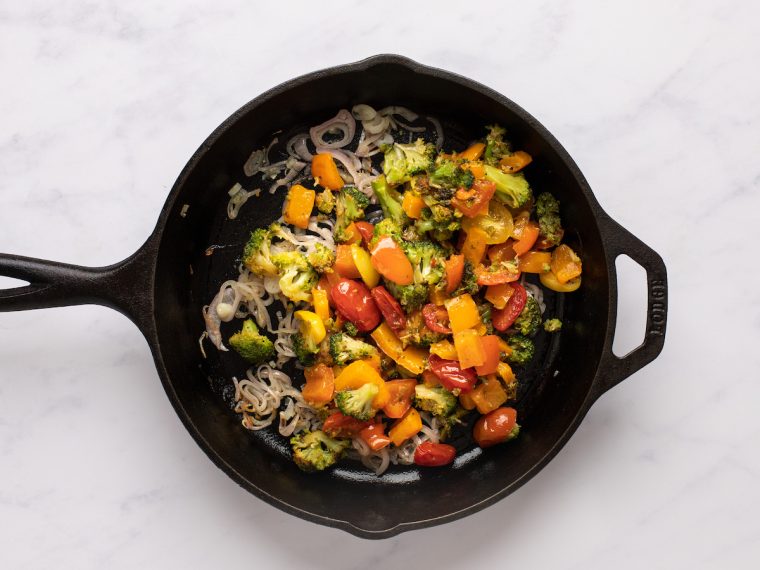 cooked vegetables added to skillet