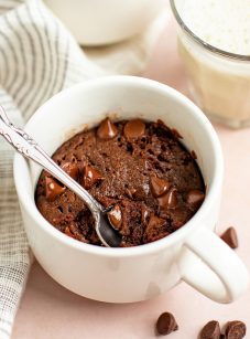 brownie in a mug with glass of milk