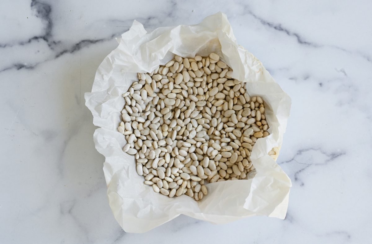 dried beans in parchment over pie crust