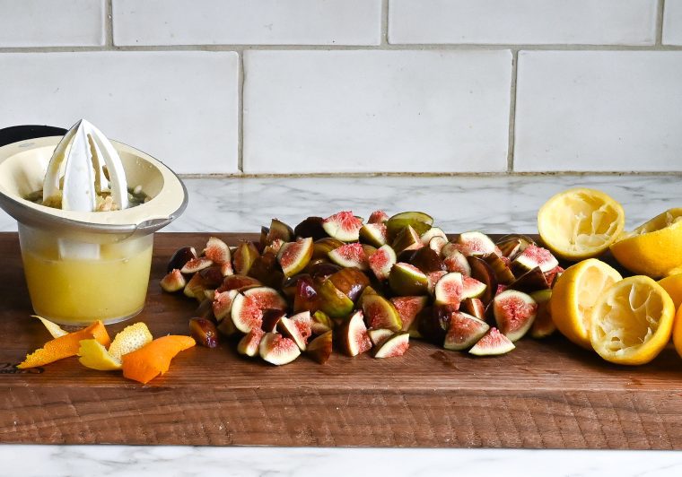 chopped figs, juiced lemons, and citrus rind on cutting board
