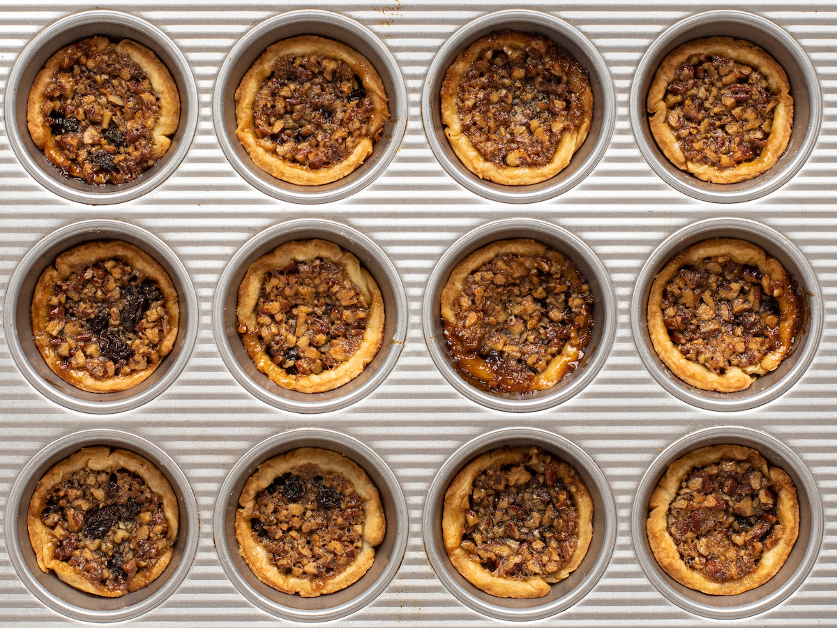 Baked Canadian butter tarts in a muffin tin.