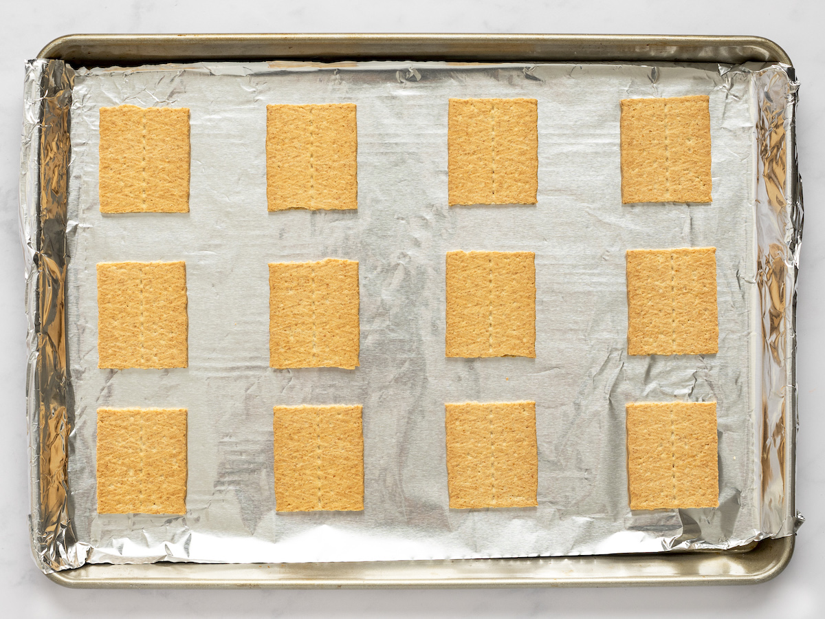 graham cracker halves on lined baking sheet