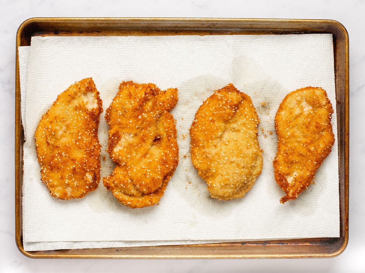 cooked chicken on baking sheet with paper towels