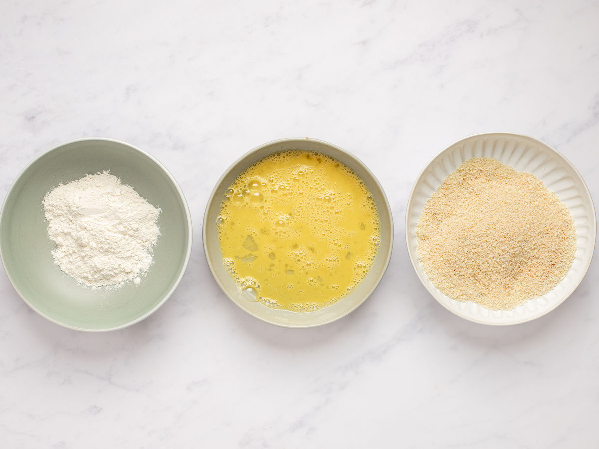 breading station with 3 bowls - flour, eggs, and panko mixture