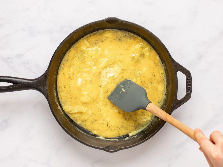 spatula moving egg mixture in skillet