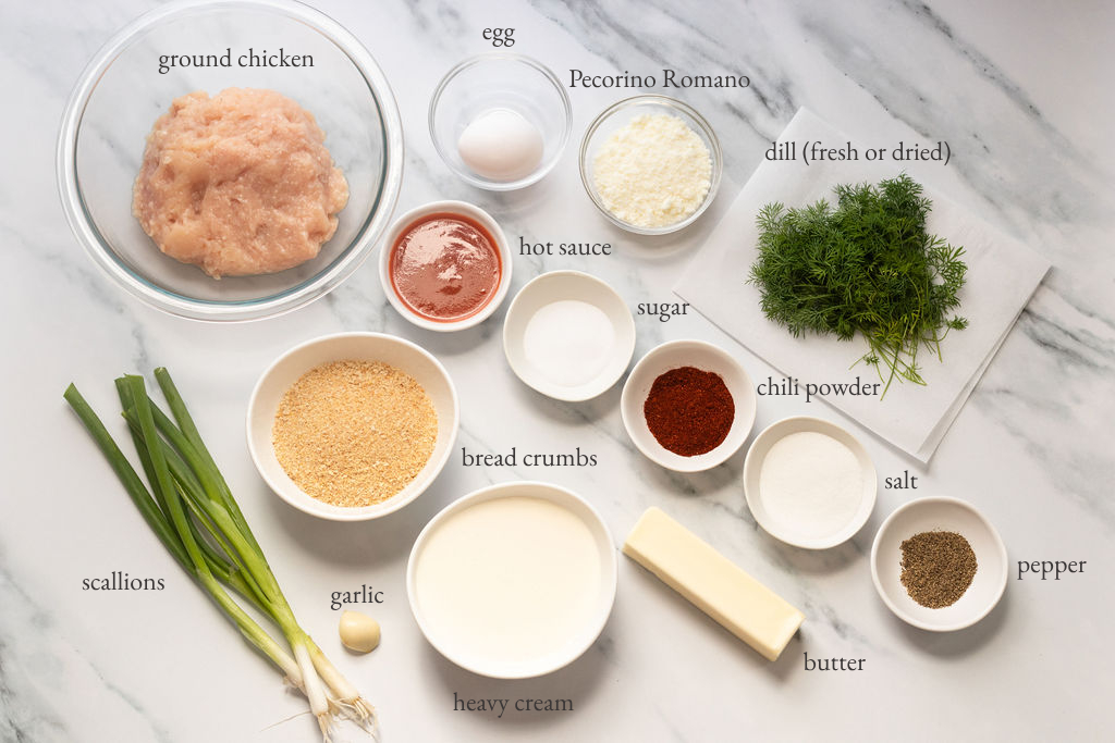 Meatball ingredients including ground chicken, dill, and egg.