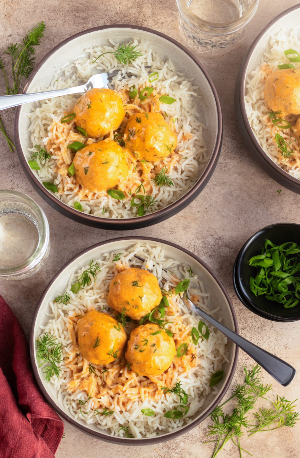 Bowls of buffalo chicken meatballs over rice.