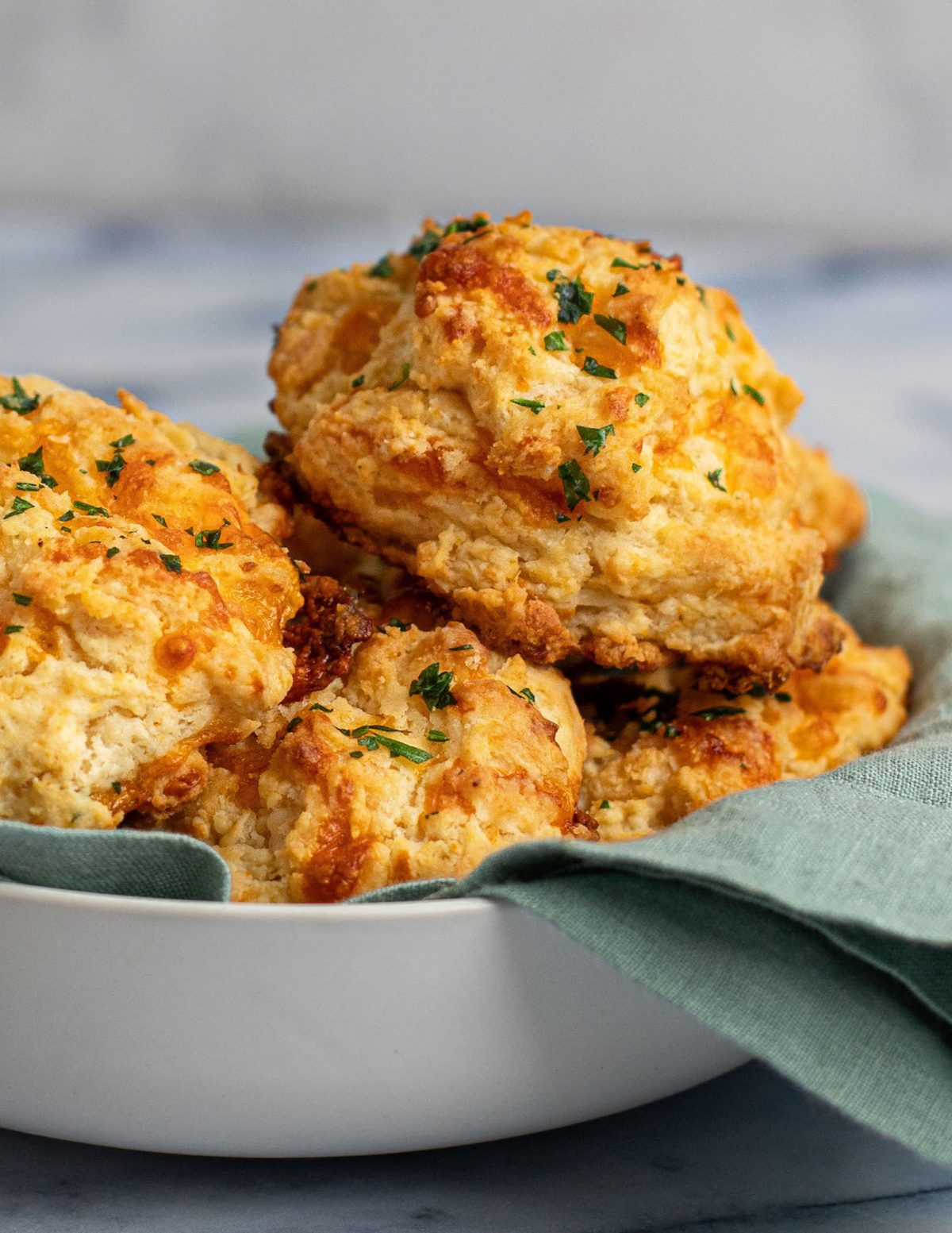 Cheddar Bay biscuits piled in a bowl.