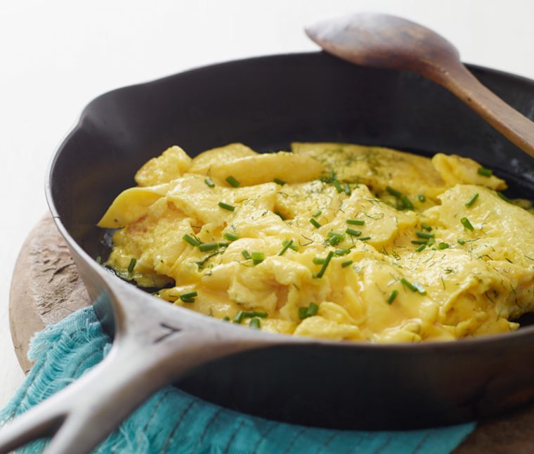 scrambled eggs with herbs in skillet