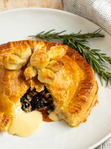 baked brie en croute on platter with rosemary