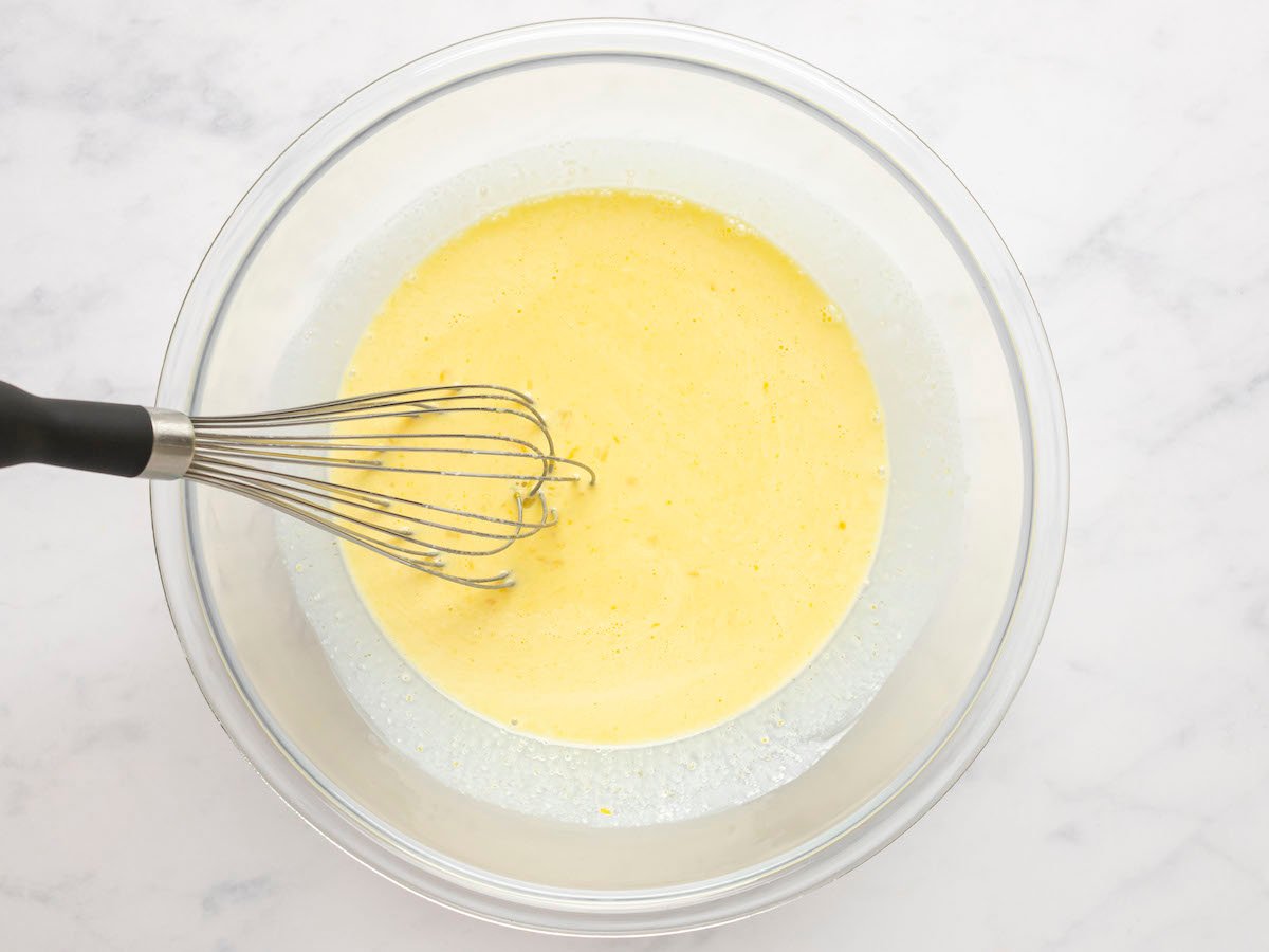 whisking egg yolks, cream, sugar, and salt