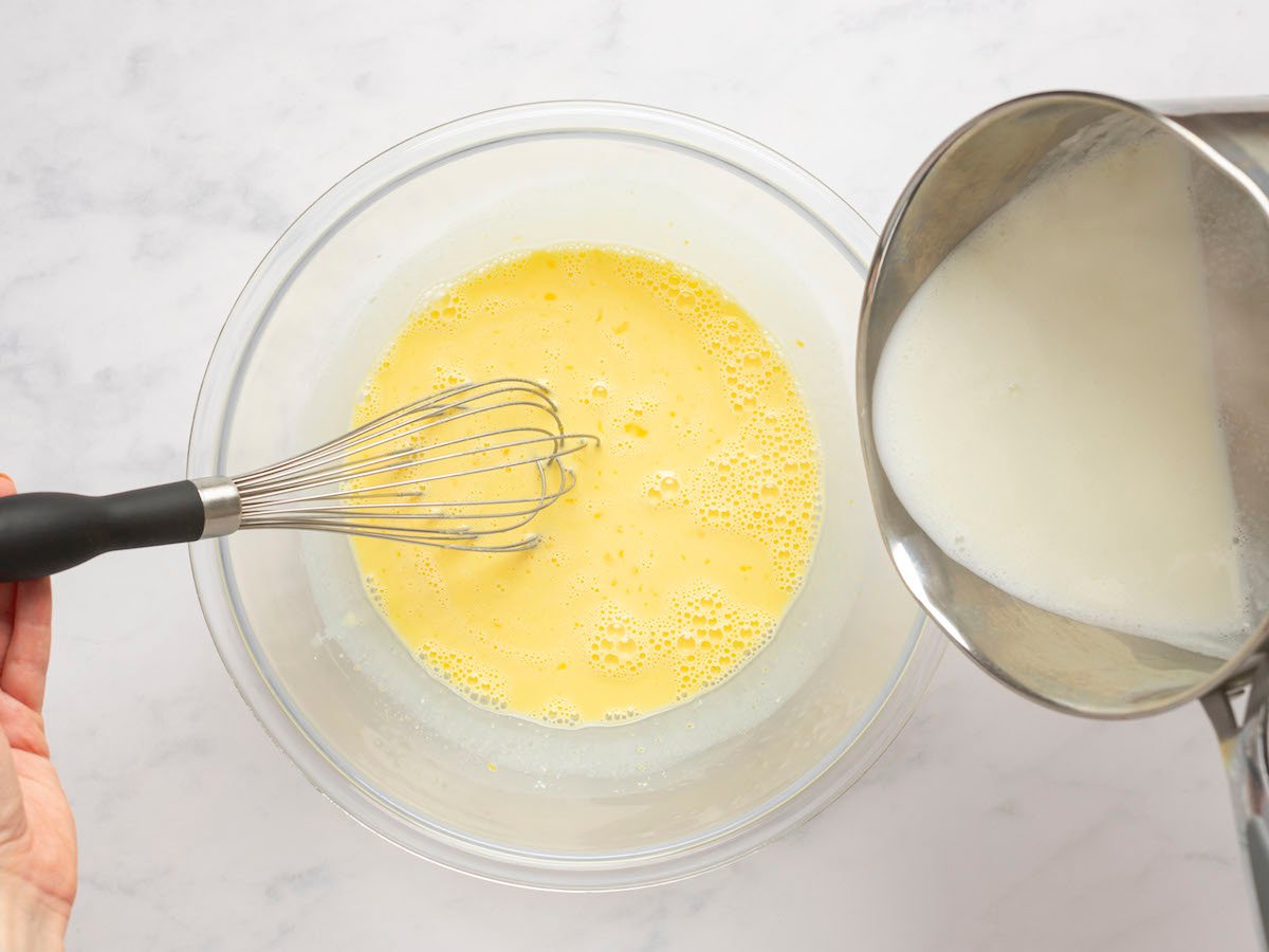 adding milk into yolk mixture and whisking constantly