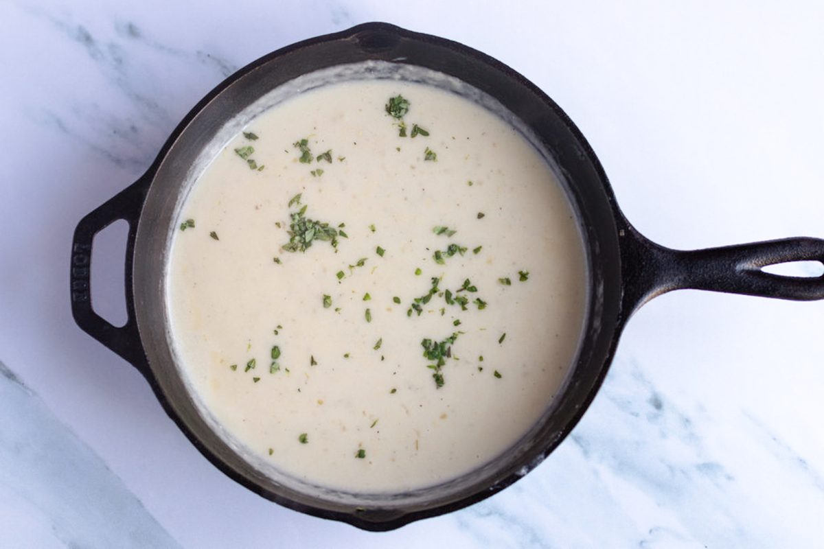 cream sauce in skillet with thyme.
