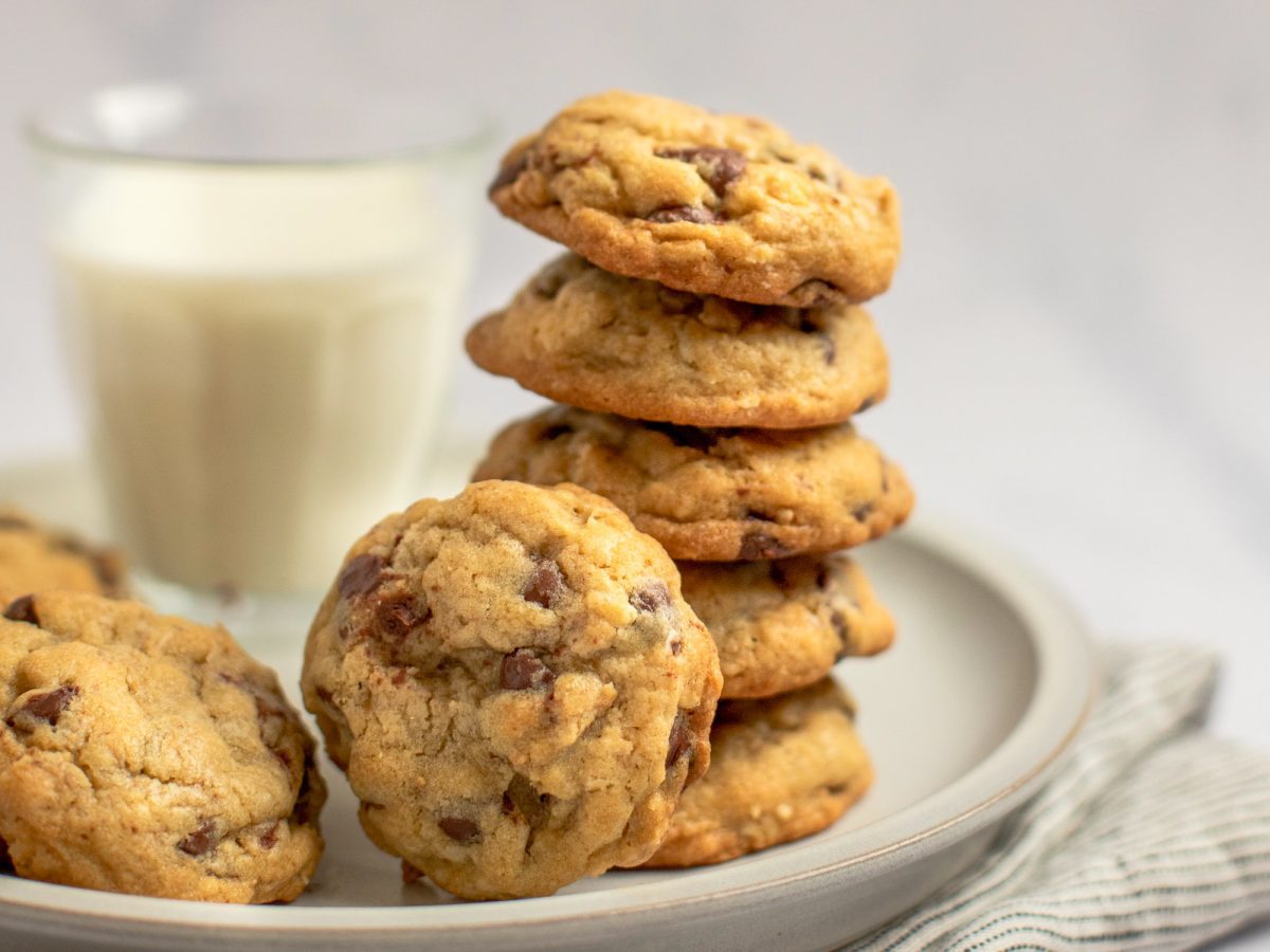 chocolate chip oatmeal cookies on plate with glass of milk