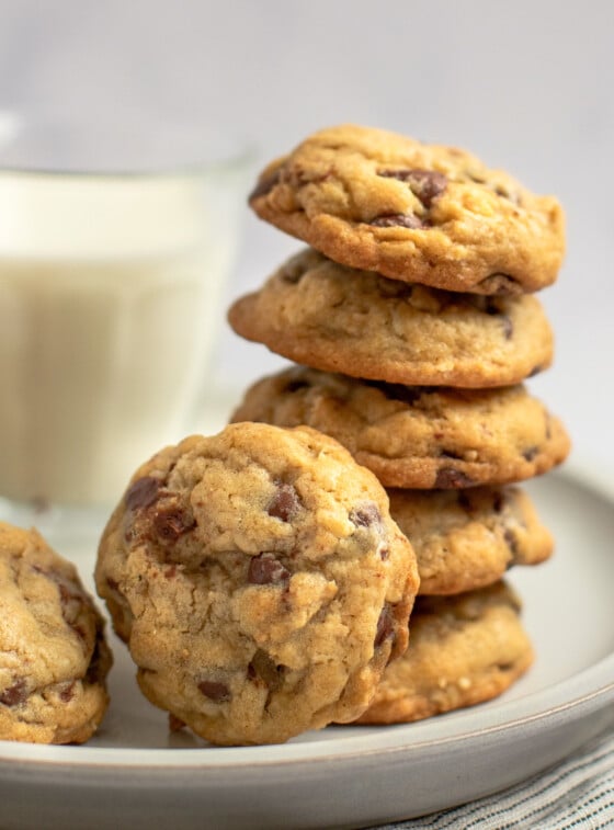 chocolate chip oatmeal cookies on plate with glass of milk