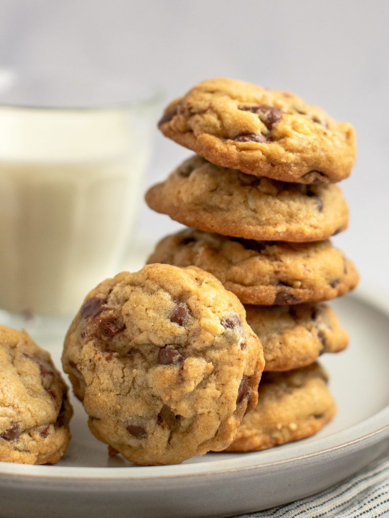 chocolate chip oatmeal cookies on plate with glass of milk