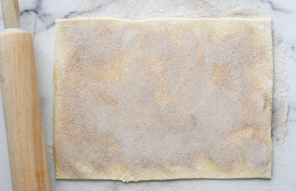cinnamon-sugar mixture pressed into puff pastry with rolling pin