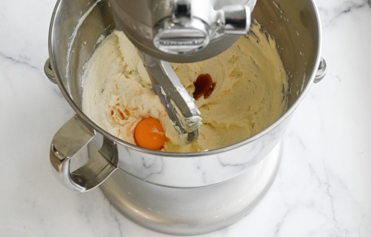 adding the egg, vanilla, and almond extract to the batter