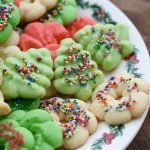 Colorful spritz cookies on a Christmas plate.