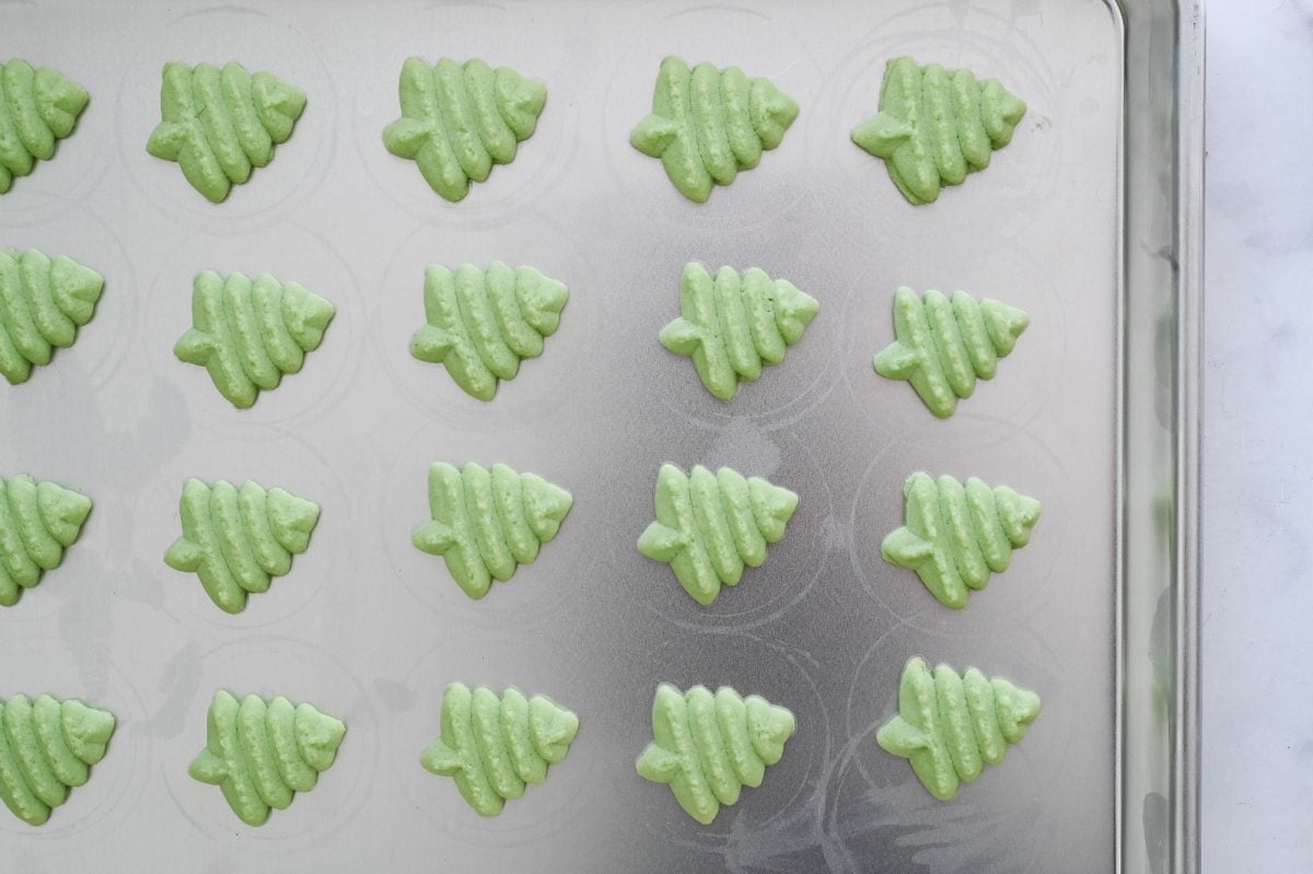 spritz cookies christmas trees on baking sheet