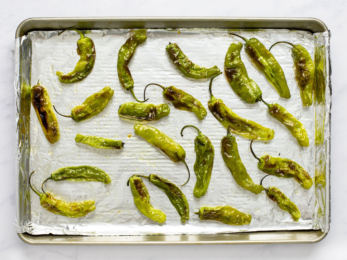 shishito peppers on foil-lined baking sheet broiled and blistered on second side