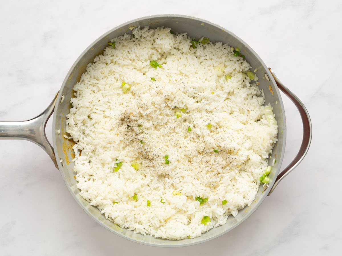 pepper and ½ teaspoon salt spread evenly over the rice in skillet.