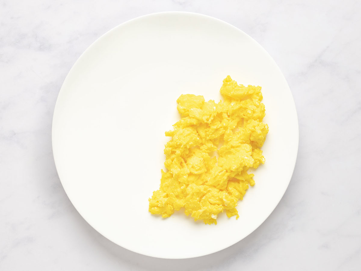 cooked scrambled eggs on plate.
