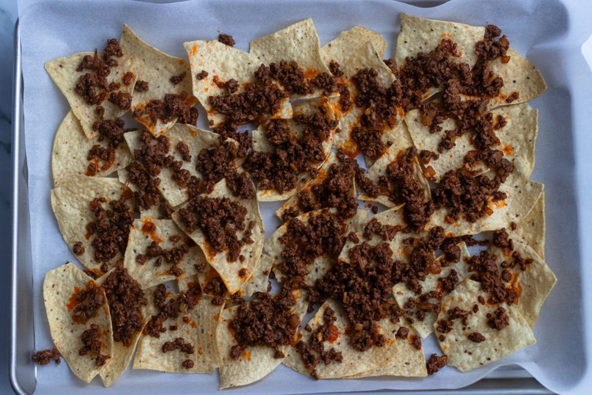 1/2 of beef mixture spread over chips on baking sheet