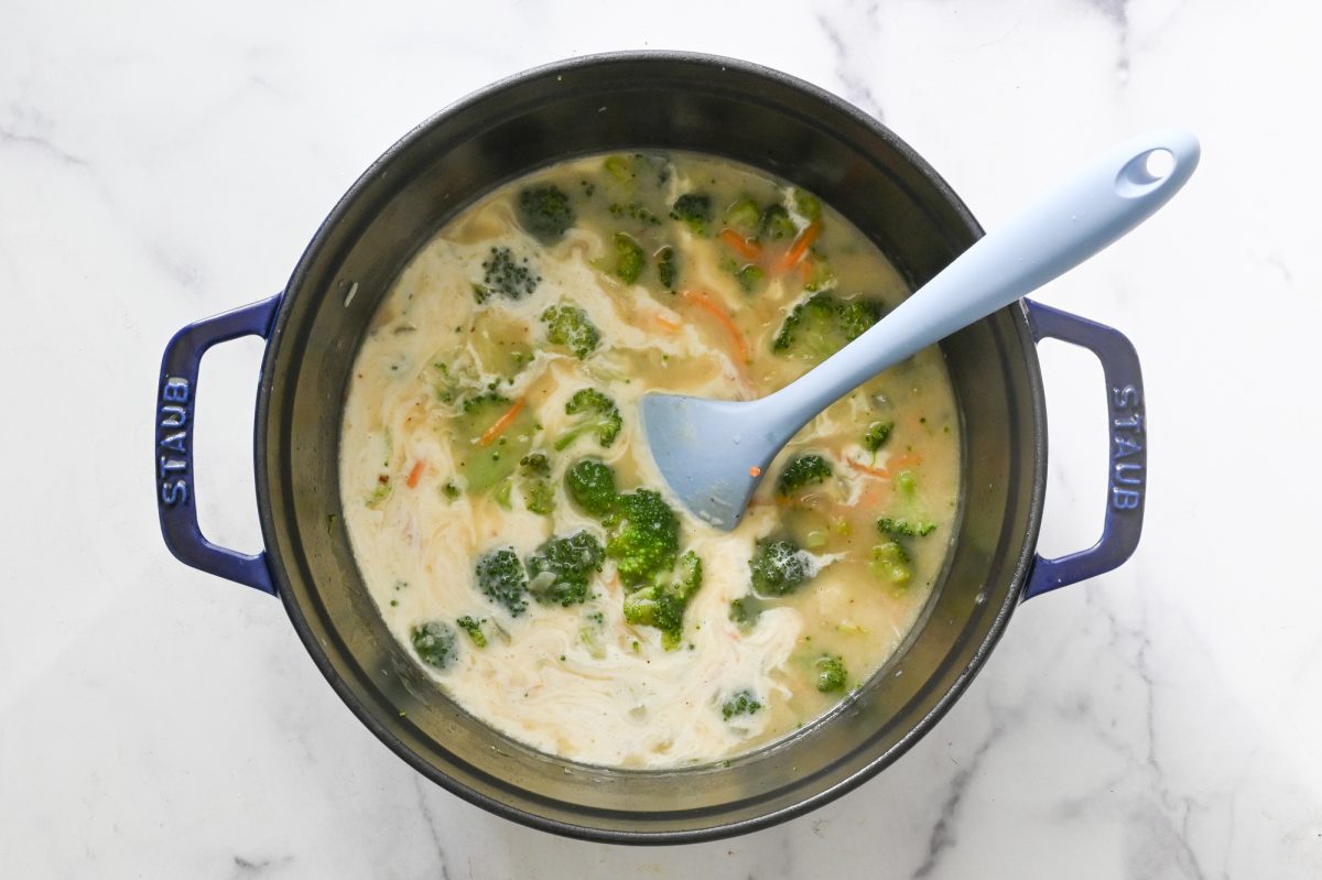 adding the heavy cream to the broccoli cheddar soup