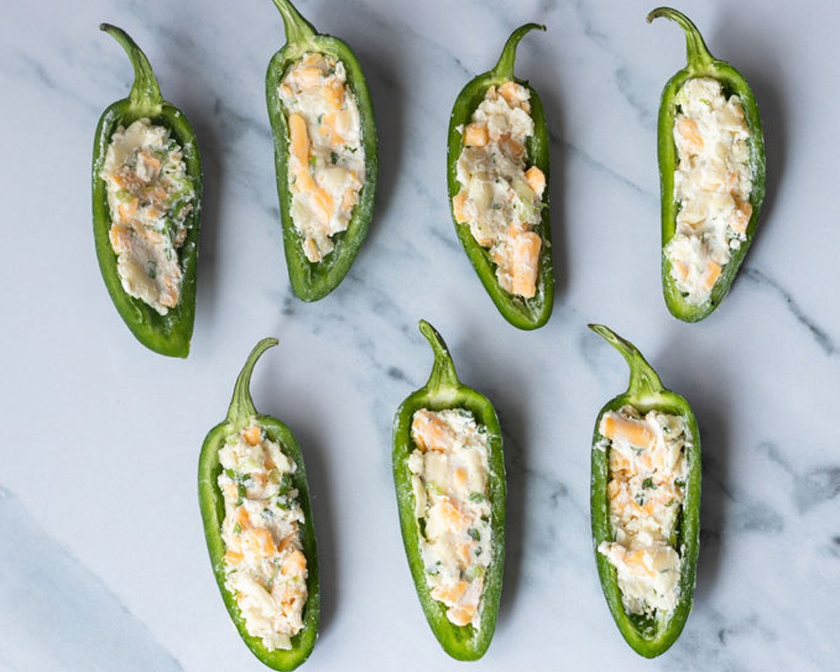 jalapeno halves filled with cream cheese, Mexican blend cheese, scallions, cilantro, lime juice, cumin, and salt filling