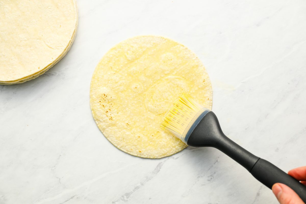 brushing tortillas with oil.