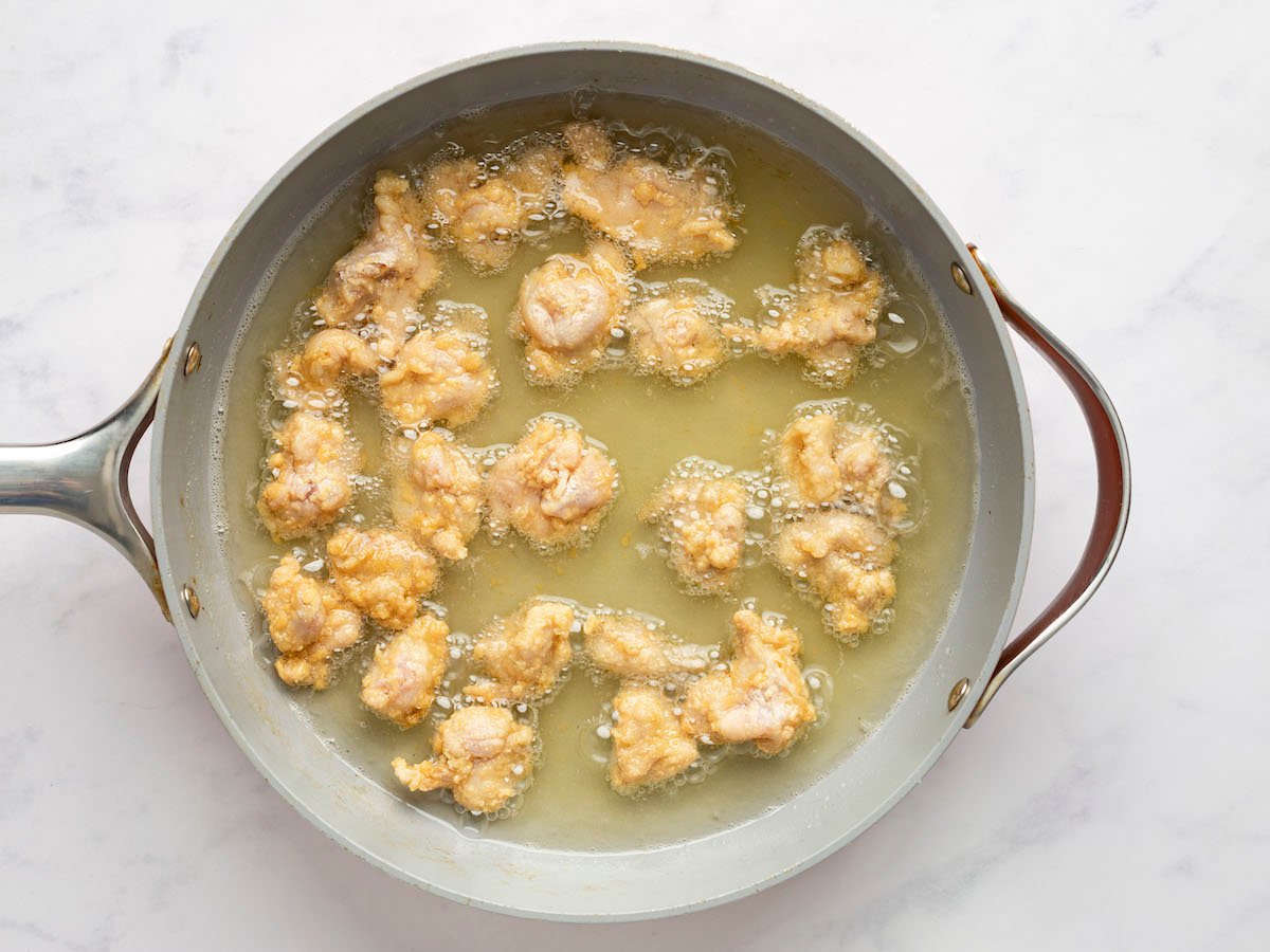 shallow frying the chicken in a skillet