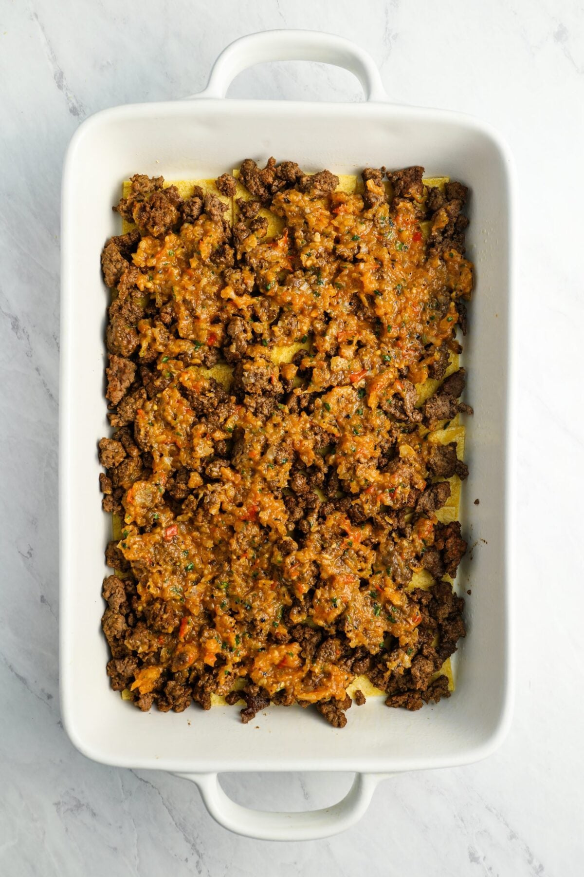 first layer of salsa in baking dish
