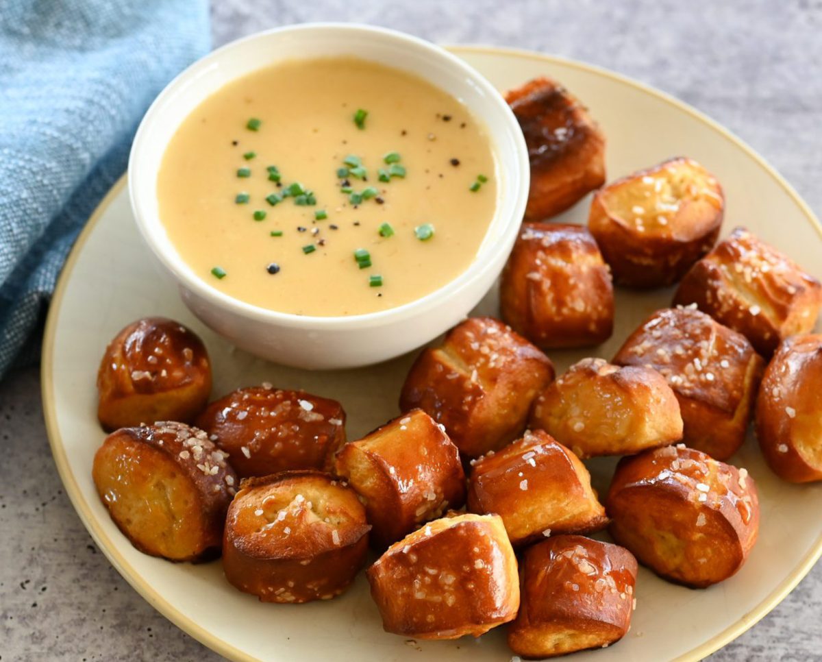 beer cheese dip on plate with pretzel bites