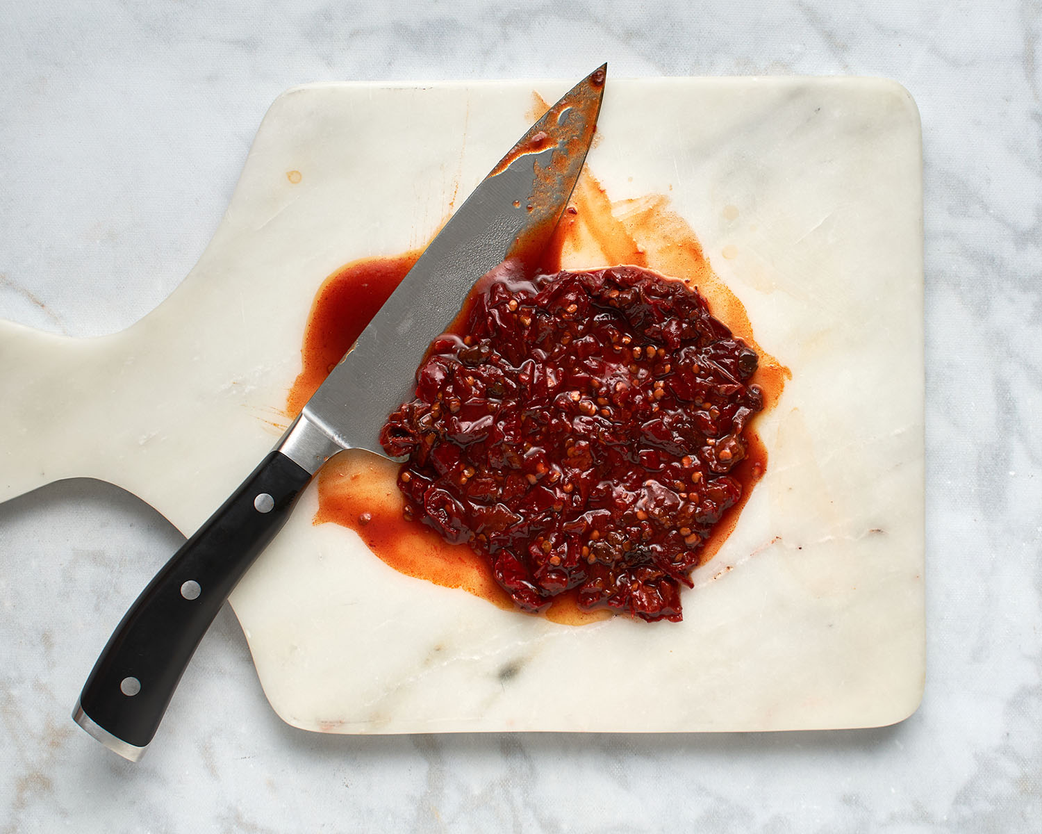 chopped chipotle pepper in adobo on marble cutting board