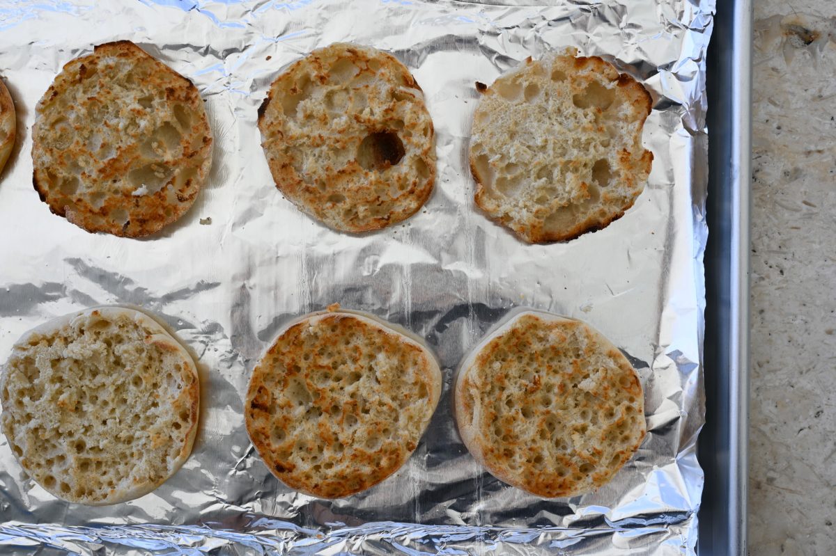 toasted English muffins on baking sheet