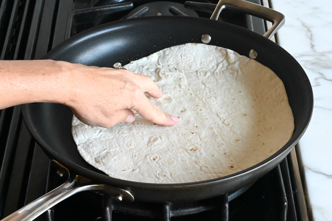 swirling tortilla in oil