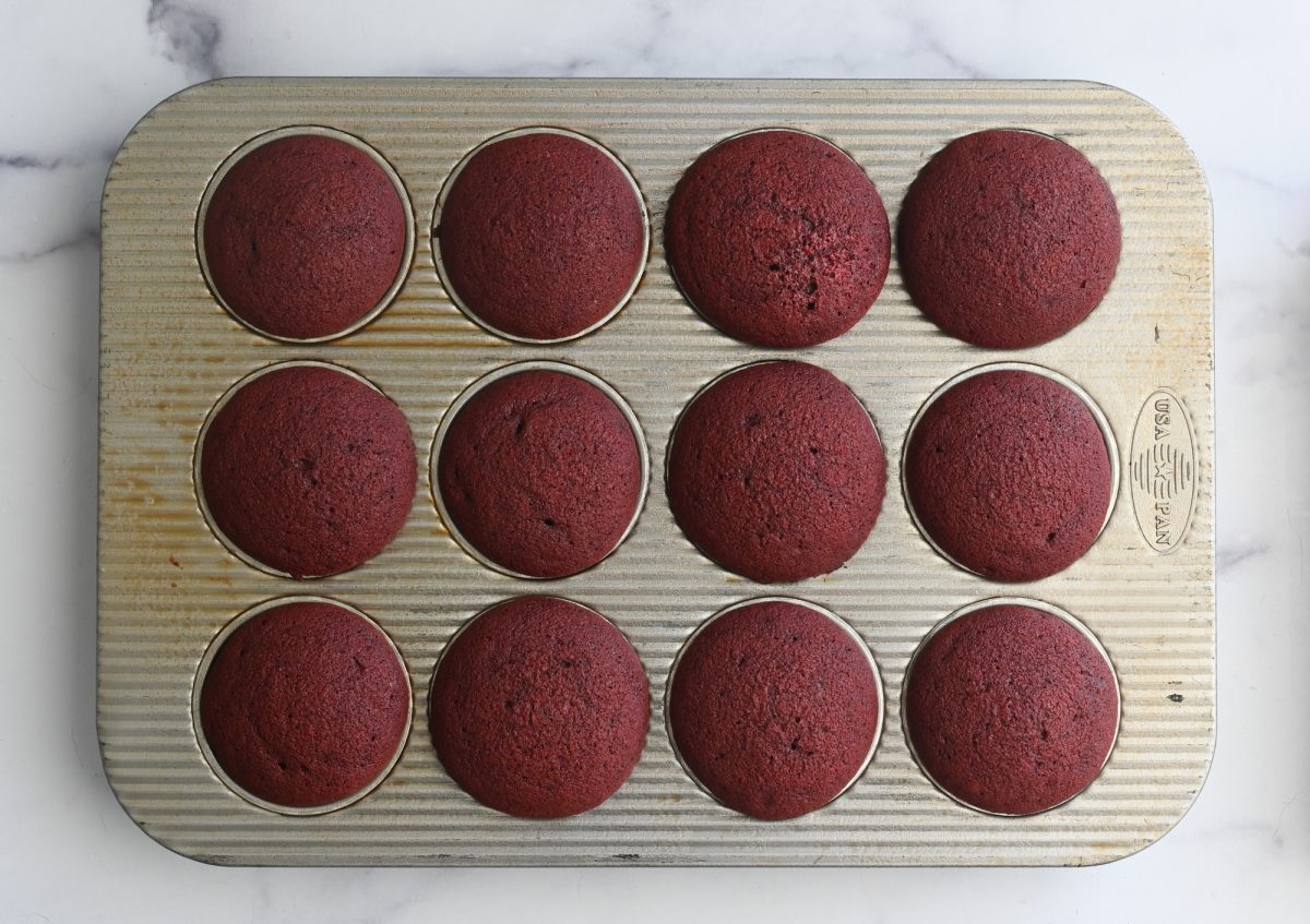 red velvet cupcakes in pan fresh out of the oven.