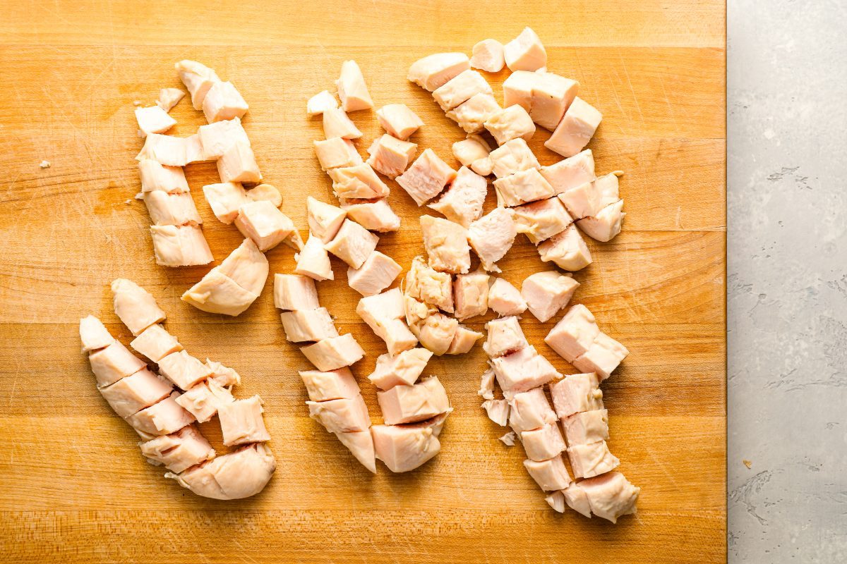 diced cooked chicken on cutting board.