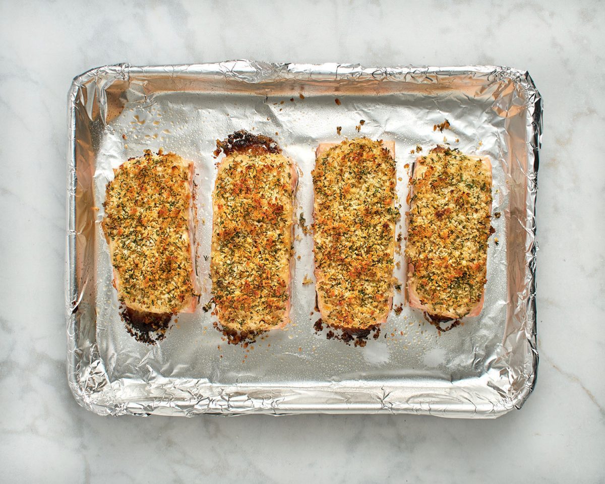 fully cooked baked salmon on foil-lined baking sheet