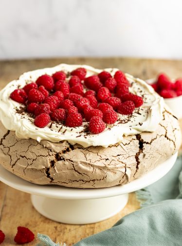 chocolate pavlova with cream and raspberries